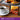 Booja-Booja chocolate truffle packs with a cup of coffee on a wooden table.