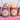 Two Booja-Booja ice cream tubs with spoons, surrounded by flowers and text about new flavors.