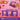 Booja-Booja Chocolate Wonders packaging on a pink background with hands holding a package.