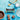 Booja-Booja salted caramel chocolate truffles on a blue background with truffles, cocoa powder, a spoon, ribbon and salt container.