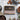 Box of Booja-BoojaFine de Champagne Chocolate Truffles on a grey background surrounded by chocolate truffles and decorative items. 