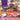 Bojagooja chocolate truffles and packaging on a decorative table with candles and flowers.